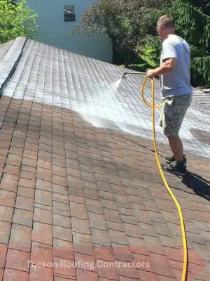 Professional shingle roof coating contractors applying protective coating on residential roof